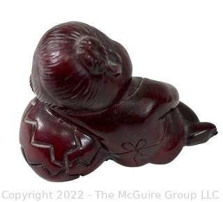 Asian Red Resin Sleeping Baby Buddha with Two Intaglio Agate Stones with Birds.  