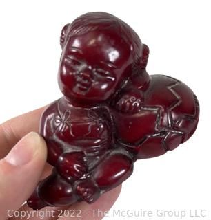 Asian Red Resin Sleeping Baby Buddha with Two Intaglio Agate Stones with Birds.  