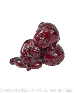 Asian Red Resin Sleeping Baby Buddha with Two Intaglio Agate Stones with Birds.  