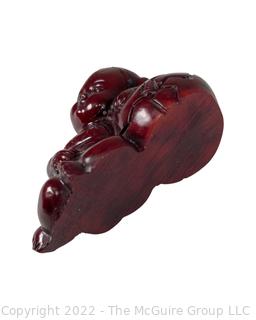 Asian Red Resin Sleeping Baby Buddha with Two Intaglio Agate Stones with Birds.  