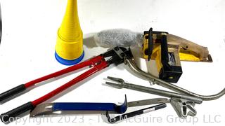 Assortment of tools including Electric McCulloch Chainsaw, Pry Bars and Medium Sized Bolt Cutter