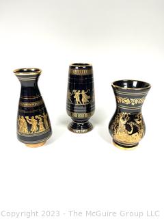 Three (3) Black, Made in Greece 24K Gold Decorated Vases.