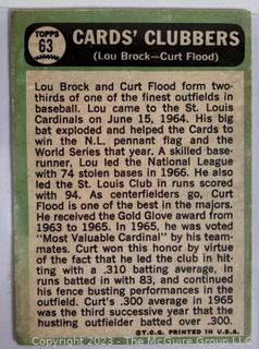 Baseball Cards of Lou Brock & Curt Flood, individual of Curt Flood, and Chipper Jones.