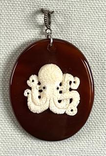 Vintage Carved Bone Octopus Charm Mounted on Cornelian Pendant with Sterling Silver Bale. 