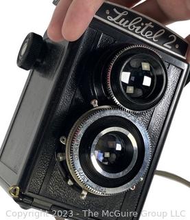 Two (2) Vintage Cameras Including a Kodak Baby Brownie Special and a Soviet LOMO Lubitel 2 Twin Lens Reflex Camera. 