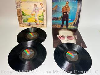 Two (2) Vinyl Record Albums: Elton John, Double Album, "Goodbye Yellow Brick Road", MCA Records 1973. Elton John, "Caribou", MCA Records 1974. Poster insert included.