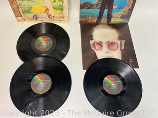 Two (2) Vinyl Record Albums: Elton John, Double Album, "Goodbye Yellow Brick Road", MCA Records 1973. Elton John, "Caribou", MCA Records 1974. Poster insert included.