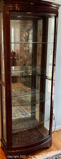 Contemporary Lighted Wood and Glass Bow Front Curio Display Cabinet with Adjustable Glass Shelves, Sliding Side Door and Mirrored Back. This is the first of two offered in this auction.  26w" x 15"d x 78"t