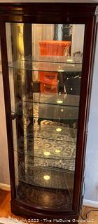 Contemporary Lighted Wood and Glass Bow Front Curio Display Cabinet with Adjustable Glass Shelves, Sliding Side Door and Mirrored Back. This is the first of two offered in this auction.  26w" x 15"d x 78"t