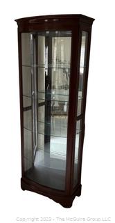 Contemporary Lighted Wood and Glass Bow Front Curio Display Cabinet with Adjustable Glass Shelves, Sliding Side Door and Mirrored Back. This is the second of two  offered in this auction.  26w" x 15"d x 78"t