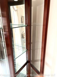 Contemporary Lighted Wood and Glass Bow Front Curio Display Cabinet with Adjustable Glass Shelves, Sliding Side Door and Mirrored Back. This is the second of two  offered in this auction.  26w" x 15"d x 78"t