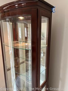 Contemporary Lighted Wood and Glass Bow Front Curio Display Cabinet with Adjustable Glass Shelves, Sliding Side Door and Mirrored Back. This is the second of two  offered in this auction.  26w" x 15"d x 78"t