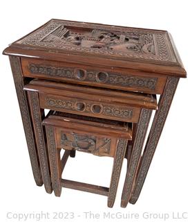 Set of Three (3) Chinoiserie Style Carved Chinese Rosewood Nesting Tables. Each carved with an individual scene that continues around the edge. With top glass inserts.  Largest Table 17"w x 12"d x 22"t