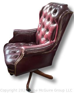 Red Tufted Leather Office Chair with Arms and Swivel Base.