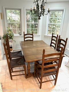 Oak Dining Table with Turned Legs and Set of 6 Ladder Back Dining Chairs with Rush Seats.  Table 40"w x 60"l x 30"t.  Chairs 40"t x19w" Four (4) side chairs & two (2) arm