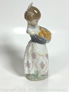 Lladro “Valencia Girl” #4841” Glazed Porcelain Figurine of a Girl Holding Oranges Made in Spain.  7" tall