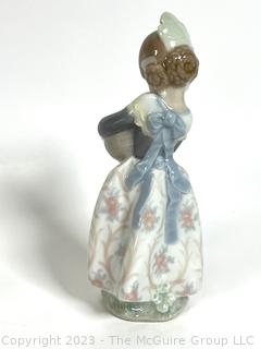 Lladro “Valencia Girl” #4841” Glazed Porcelain Figurine of a Girl Holding Oranges Made in Spain.  7" tall