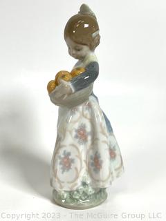 Lladro “Valencia Girl” #4841” Glazed Porcelain Figurine of a Girl Holding Oranges Made in Spain.  7" tall