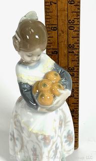 Lladro “Valencia Girl” #4841” Glazed Porcelain Figurine of a Girl Holding Oranges Made in Spain.  7" tall