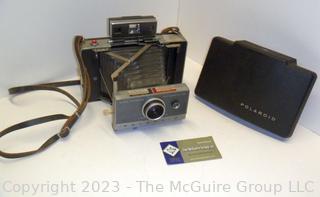 Polaroid Automatic 100 Land Camera. Appears to be in working condition and contains film