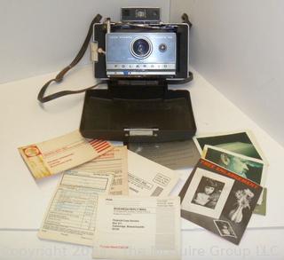 Polaroid Automatic 100 Land Camera. Appears to be in working condition and contains film