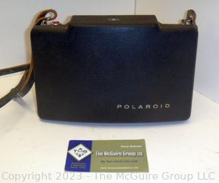 Polaroid Automatic 100 Land Camera. Appears to be in working condition and contains film