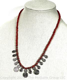 Red Bead with Hammered Metal Pendants. 