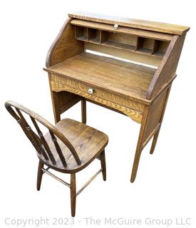 Antique Child's Wooden Roll Top Desk with Chair. Desk measures 27 x 15 x 34". Chair measures 13w x 28" Tall.