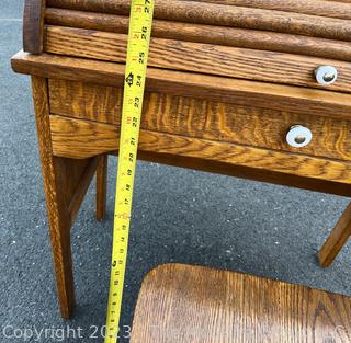 Antique Child's Wooden Roll Top Desk with Chair. Desk measures 27 x 15 x 34". Chair measures 13w x 28" Tall.