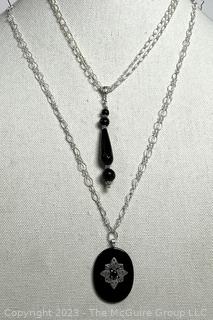 Two (2) Black Onyx Pendants on Sterling Silver Chain Necklaces.