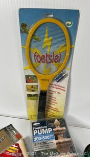 Group of Household Items Including Racquet Game and Bullet Mold