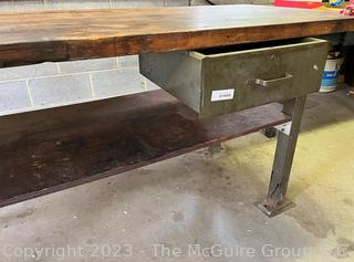 Metal Frame Work Table with Lower Shelf, 1 Drawer and Wooden Top and with Attached Bench Vise. Measures 72L x 30D x 34"T