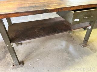 Metal Frame Work Table with Lower Shelf, 1 Drawer and Wooden Top and with Attached Bench Vise. Measures 72L x 30D x 34"T