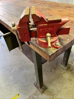 Metal Frame Work Table with Lower Shelf, 1 Drawer and Wooden Top and with Attached Bench Vise. Measures 72L x 30D x 34"T