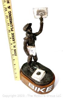 Cast Bronze of Newsboy Signed by Artist Jim McCartin (1919 - 1999) on Wood Base.  13" tall. 