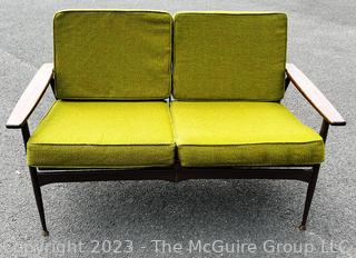 Mid Century Modern Steel Framed Sofa with Walnut Armrests and Green Cushions.  50" long