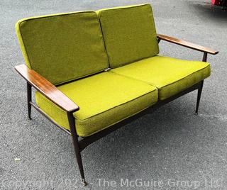 Mid Century Modern Steel Framed Sofa with Walnut Armrests and Green Cushions.  50" long