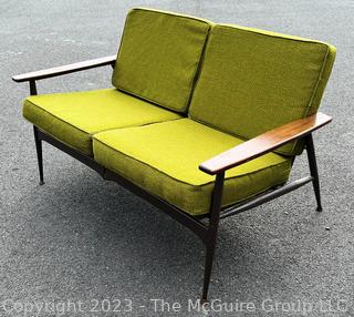 Mid Century Modern Steel Framed Sofa with Walnut Armrests and Green Cushions.  50" long