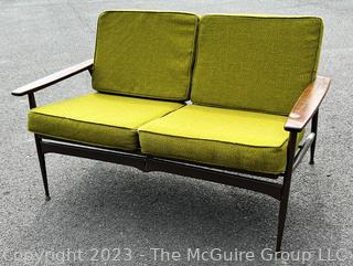 Mid Century Modern Steel Framed Sofa with Walnut Armrests and Green Cushions.  50" long