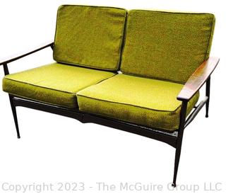 Mid Century Modern Steel Framed Sofa with Walnut Armrests and Green Cushions.  50" long