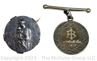 Two (2) Antique Silver French Maternity Metals or Charms.  One mounted as brooch the other made into love token dated 1917.