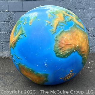 Large Painted Fiberglass World Globe with Hanging Wire.  Some dents and cracks. 47" diameter. 