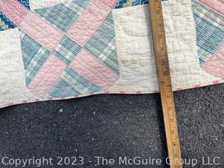 Vintage Hand Stitched Flour Sack Quilt in the Foundry Pattern. Some staining. Measures 86" x 72".