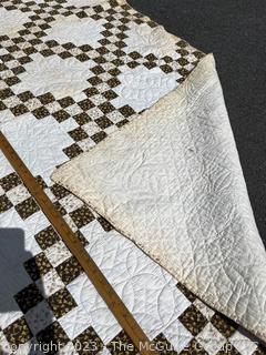 Vintage Hand Stitched Flour Sack Quilt in the  Double Irish Chain Pattern. Some staining. Measures 79" x 72".