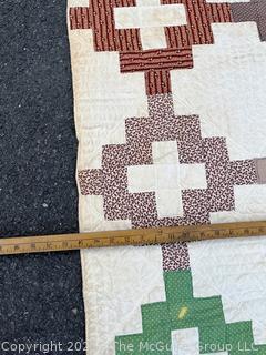 Vintage Hand Stitched Flour Sack Quilt in the Chimney Sweep Pattern. Some staining. Measures 79" x 72".