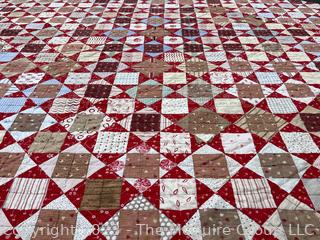 Vintage Hand Stitched Flour Sack Quilt in the Hour Glass Chain Pattern. Some staining. Measures 83" x 77".