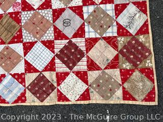 Vintage Hand Stitched Flour Sack Quilt in the Hour Glass Chain Pattern. Some staining. Measures 83" x 77".