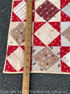 Vintage Hand Stitched Flour Sack Quilt in the Hour Glass Chain Pattern. Some staining. Measures 83" x 77".