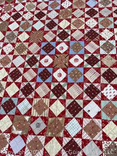 Vintage Hand Stitched Flour Sack Quilt in the Hour Glass Chain Pattern. Some staining. Measures 83" x 77".