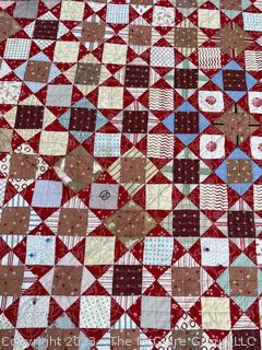 Vintage Hand Stitched Flour Sack Quilt in the Hour Glass Chain Pattern. Some staining. Measures 83" x 77".